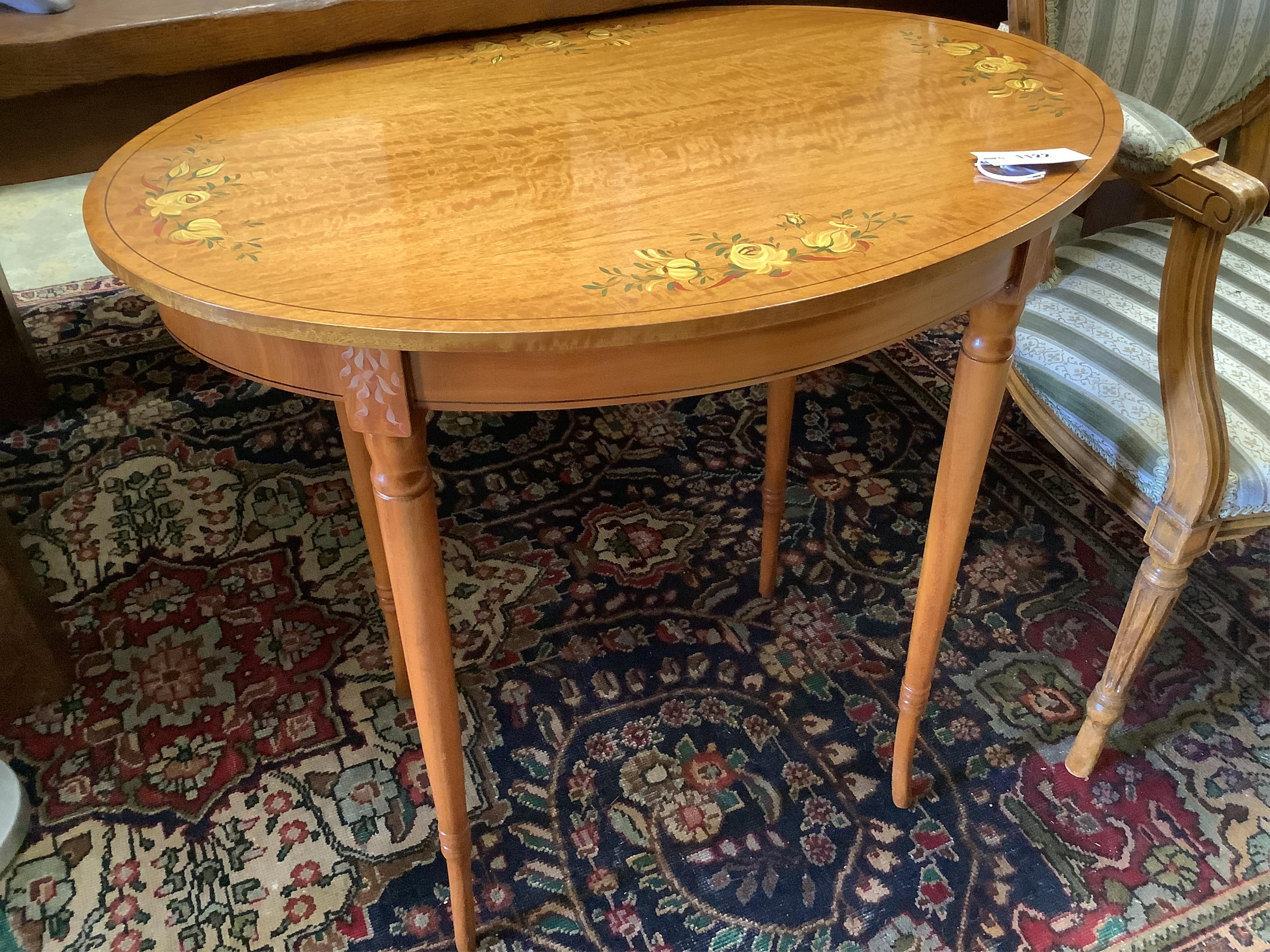 A painted oval satinwood occasional table, width 74cm, depth 51cm, height 70cm
